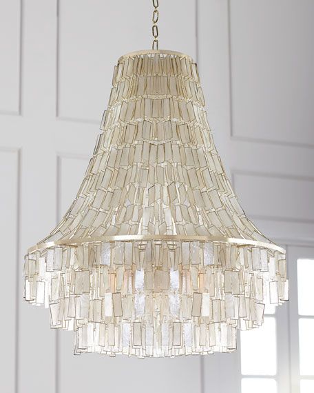 a chandelier hanging from a ceiling in a room with white walls and windows