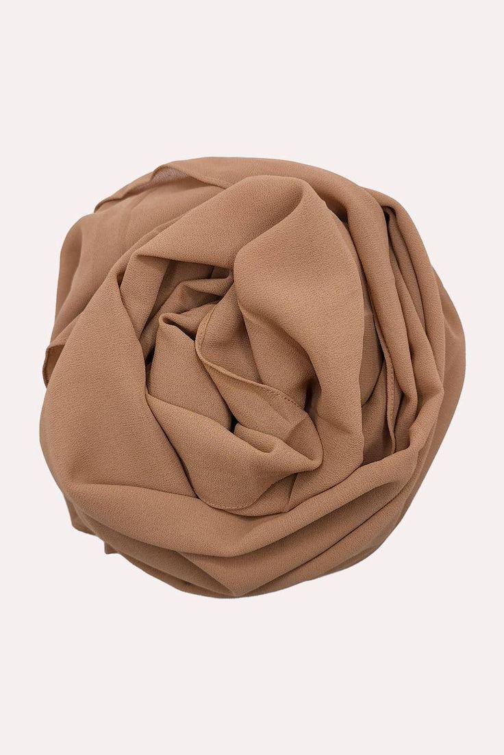 Our Premium Chiffon Hijabs are a worthy addition to your wardrobe thanks to their silky, breathable, opulent, and soft-to-the-touch fabric. They are cut, stitched, and created to perfection to offer you a hijab experience like no other. Thanks to the wrinkle-resistant and easy-to-maintain fabric, you can enjoy easy-breezy crisp looks every time with our Premium Chiffon Hijab - Pyramid, which is a flattering golden medium brown hue. These hijabs do not sacrifice luxury, comfort, or elegance. They Elegant Niqab For Eid, Elegant Solid Niqab For Eid, Solid Chiffon Hijab Modest Style, Solid Color Chiffon Hijab In Modest Style, Modest Solid Color Chiffon Hijab, Chiffon Hijab, Easy Breezy, Medium Brown, Chiffon Fabric