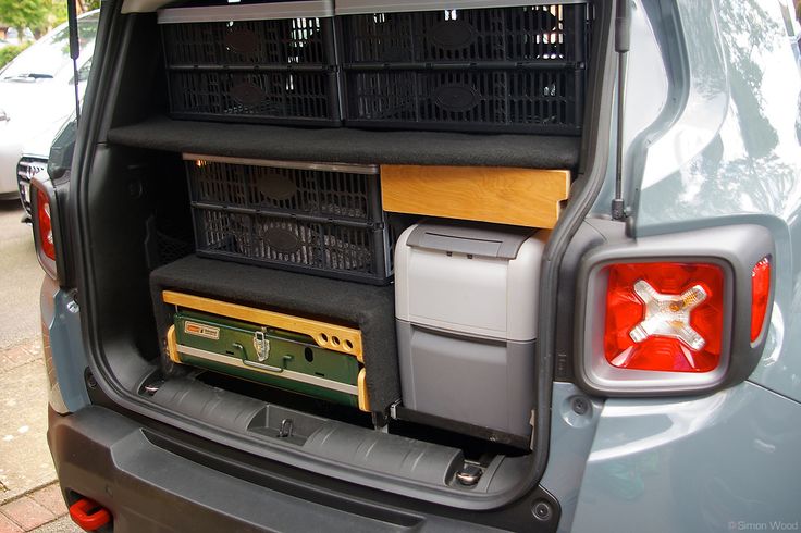 the back end of a car with some crates in it