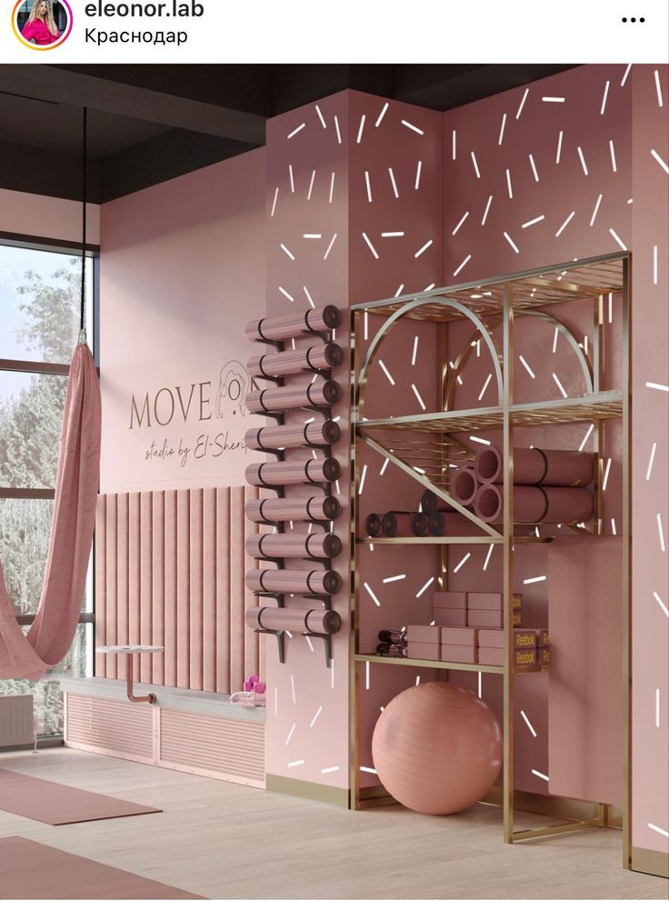 a room with pink walls and shelves filled with yoga mats