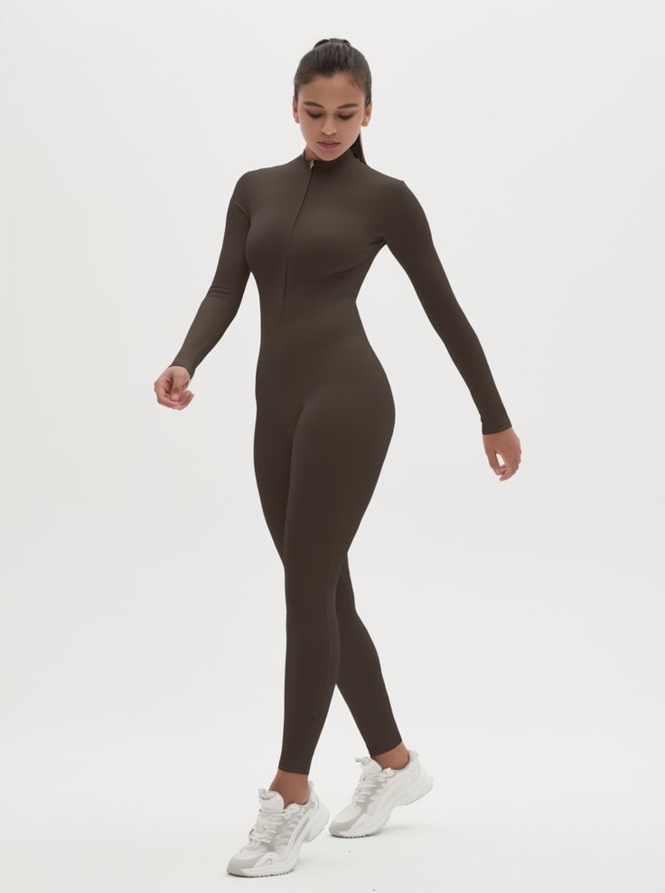 Why We Love It: The Hannah Long Sleeve Zipper Bodysuit is the epitome of sleek, modern activewear. This bodysuit combines functionality with a streamlined design, ensuring you look and feel your best whether you're at the gym or out and about. Fit and Features: Front Zipper Detail: The front zipper allows for easy wear and adjustability, adding a chic element to this versatile piece. Long Sleeves with Thumbholes: Provides added coverage and a secure fit, perfect for cooler weather or intense workouts. Buttery Soft Fabric: This bodysuit feels like a second skin, offering unmatched comfort and flexibility. High Performance: The four-way stretch material ensures maximum freedom of movement, making it ideal for any activity. Moisture-Wicking Technology: Keeps you dry and comfortable, no matter Functional Fitted Unitard For Yoga, Solid Fitted Sportswear Bodysuit, Fitted Functional Unitard For Yoga, High Stretch Athleisure Unitard With Thumbholes, Sporty High Stretch Unitard With Thumbholes, High Stretch Sporty Unitard With Thumbholes, Fitted Athleisure Bodysuit With Thumbholes, Stretch Functional Unitard, High Stretch Elastane Unitard For Gym