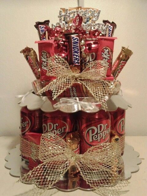 a cake made to look like a stack of cans with chocolates and candies on top