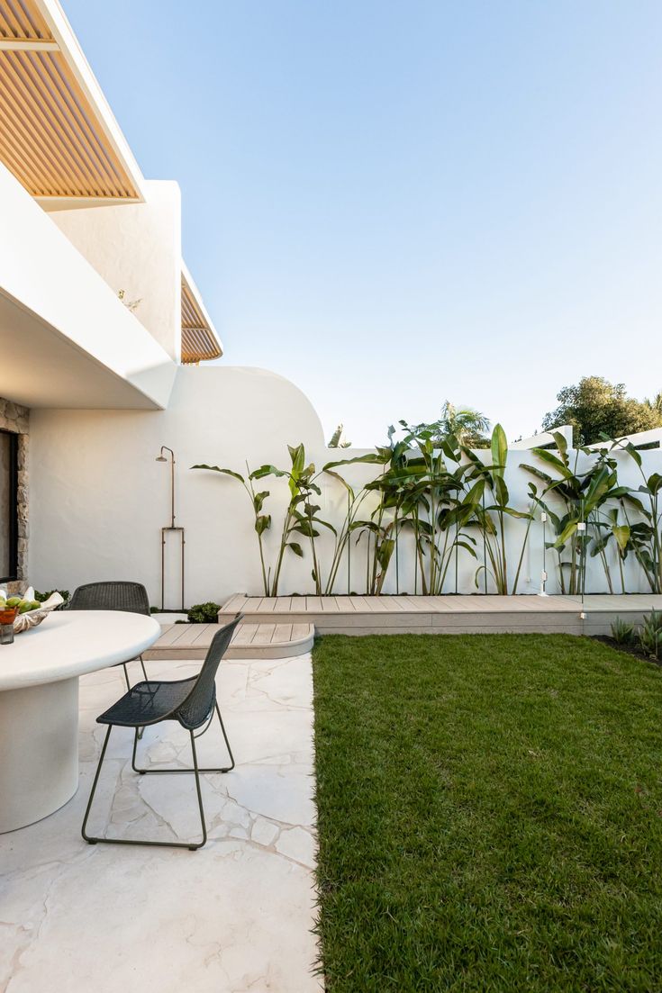 an outdoor dining area with table and chairs