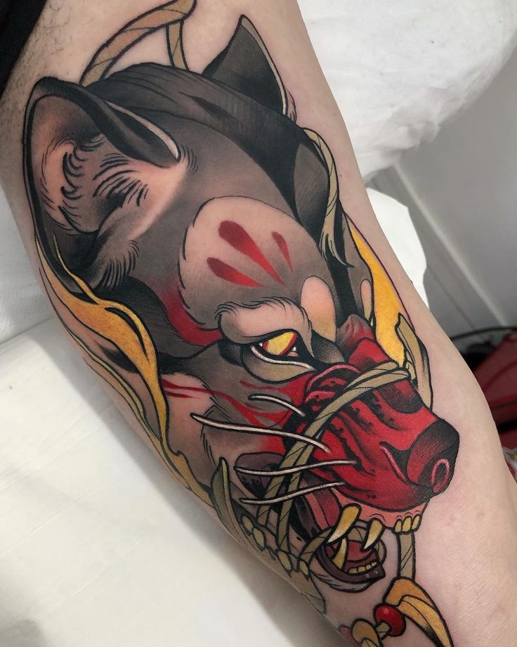 a man's leg with a tattoo of a wolf wearing a hat and holding a baseball bat