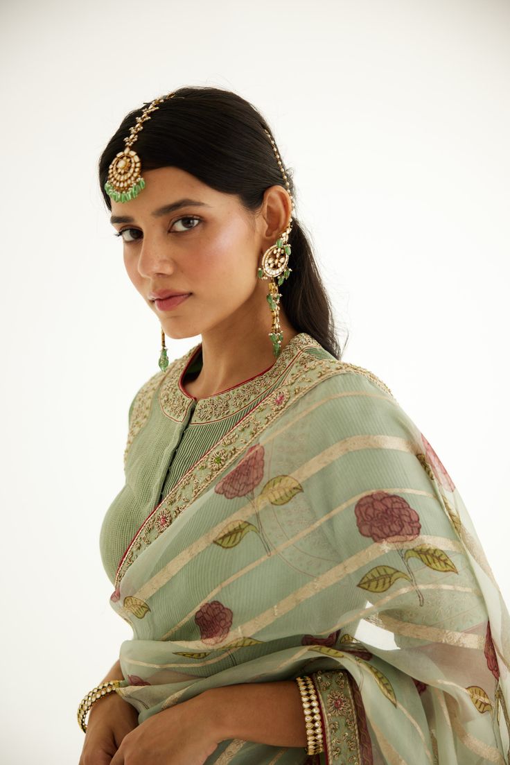 Elevate your style with our zardozi-embroidered hand block printed silk organza sari, perfectly paired with a pin-tucked blouse. This ensemble exudes timeless elegance and sophistication, making it a perfect choice for grand occasions and celebrations. Festive Pista Green Chanderi Pre-draped Saree, Pista Green Cotton Silk Pre-draped Saree For Wedding, Traditional Pista Green Organza Pre-draped Saree, Green Resham Embroidered Cotton Silk Blouse Piece, Traditional Pista Green Pre-draped Saree With Sheer Dupatta, Green Anarkali Chanderi Blouse Piece, Pista Green Cotton Silk Blouse Piece For Wedding, Traditional Green Organza Blouse Piece, Wedding Blouse Piece In Pista Green Cotton Silk