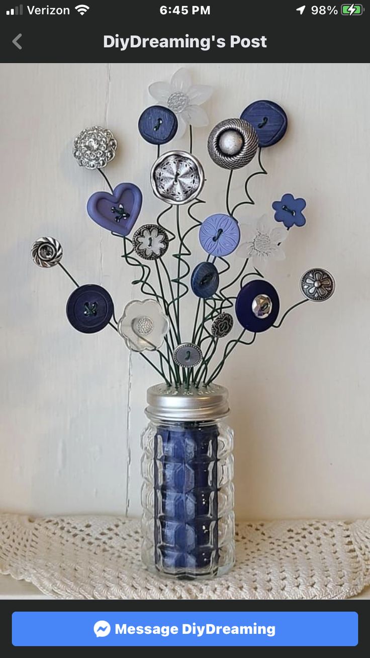 a vase filled with blue flowers sitting on top of a table