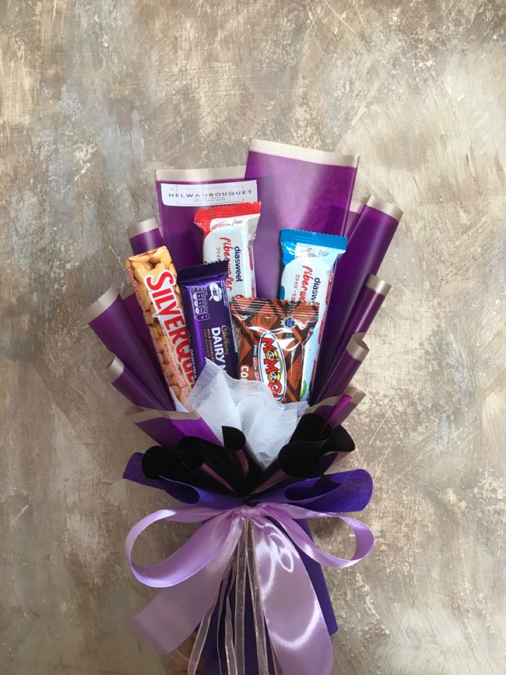 a purple vase filled with candy and candies