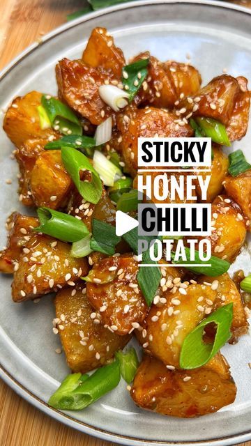 sticky honey chili potato on a plate with sesame seeds