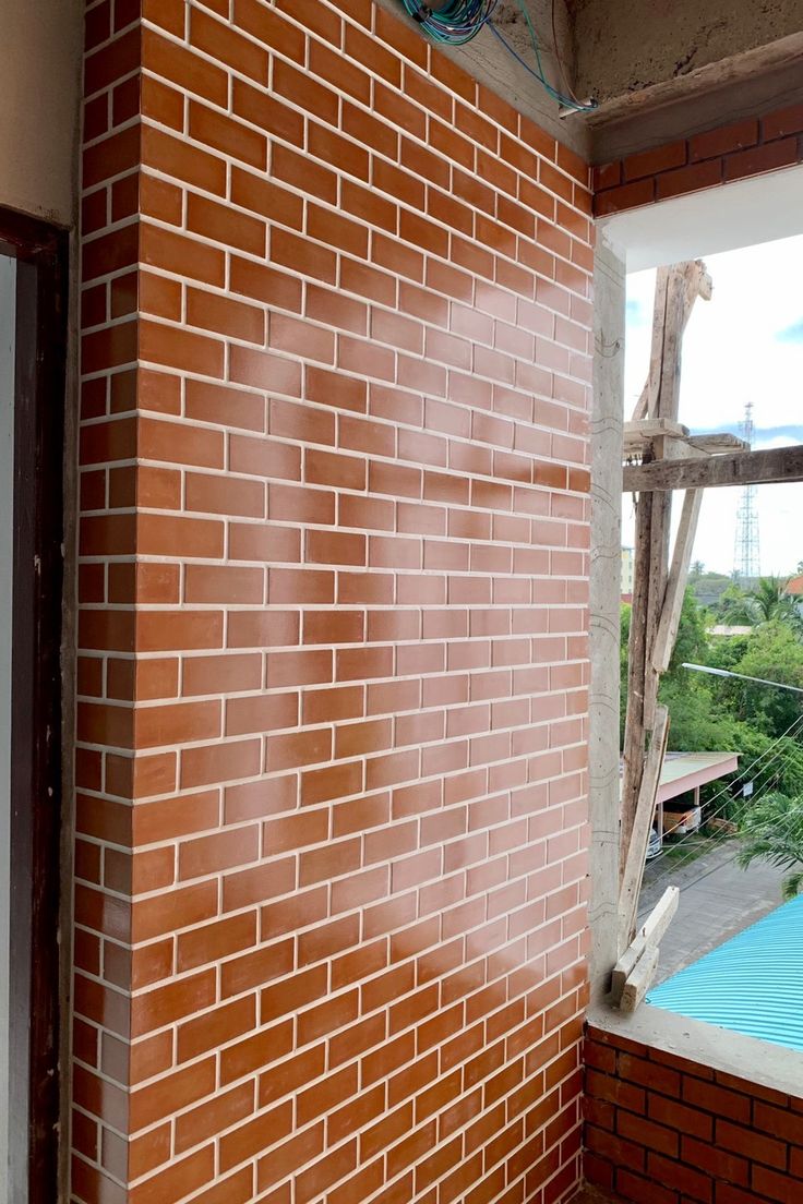 a red brick wall next to a window