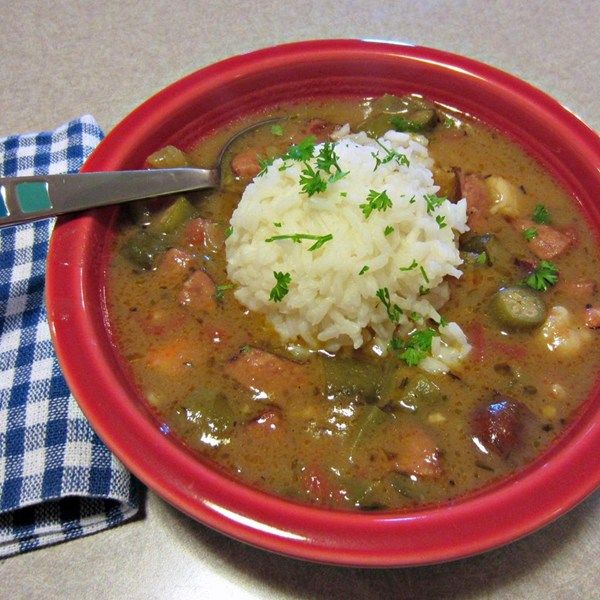 a red bowl filled with stew and rice