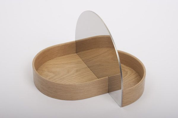 a wooden bowl with a mirror on the top and one section cut out to look like a heart