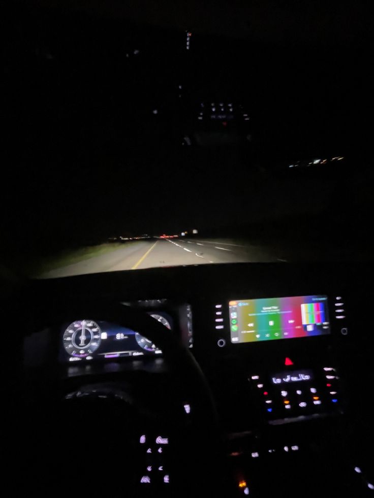 the dashboard of a car at night time