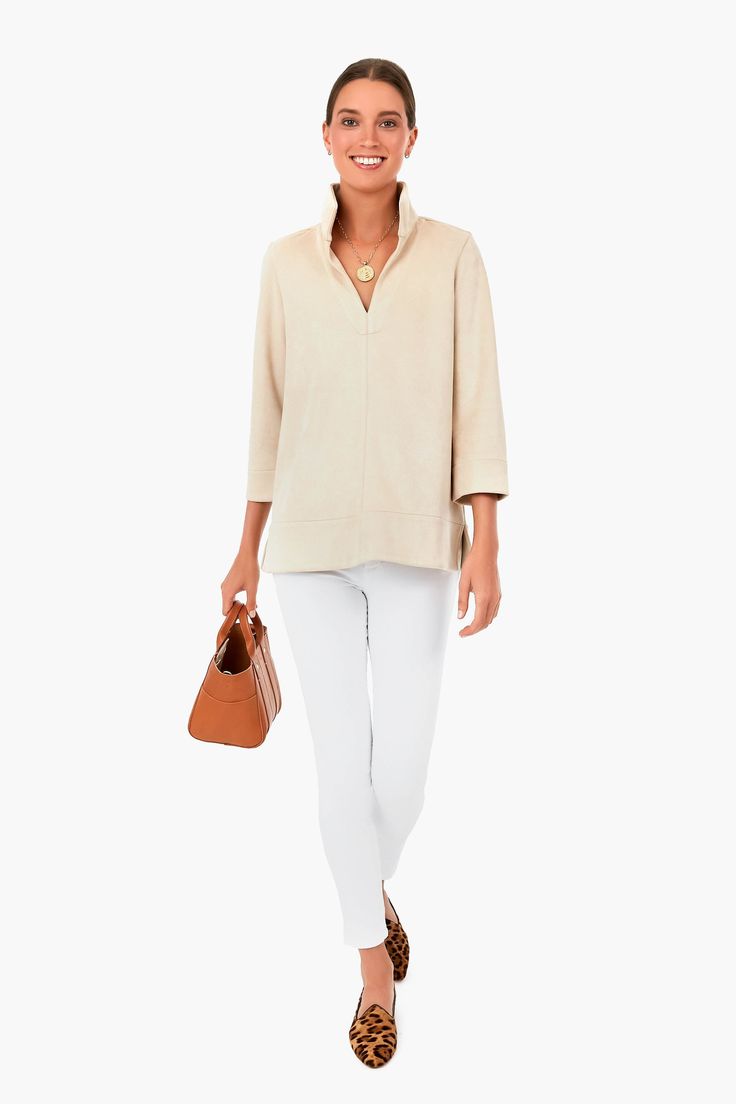 The Margot Blouse is one of our favorite silhouettes and this neutral hue is an added bonus. Updated in a soft faux suede, the sleek stand collar creates a classic, sophisticated look but also pairs well with denim for a more casual vibe. We are wearing this top from meetings to date night with a quick change of accessories! Stand collar Slits at back of elbows Faux suede Longer length Material: 60% Wool, 40% Polyester Care: Dry clean only. Dry clean prior to first wear Beige Blouse For Business Casual In Fall, Fall Business Casual Beige Blouse, Elegant Fall Blouse For Everyday Wear, Elegant Everyday Blouse For Fall, Versatile Beige Blouse For Fall, Elegant Beige Blouse For Everyday, Elegant Beige Everyday Blouse, Elegant Everyday Beige Blouse, Chic Collared Blouse For Casual Gatherings