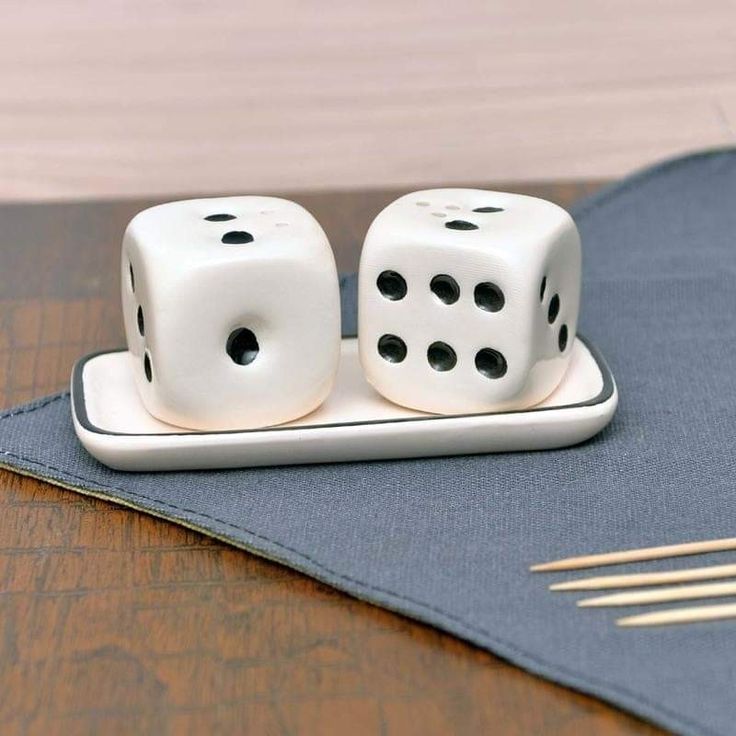 two white dices sitting on top of a wooden table