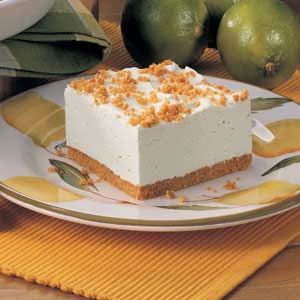 a piece of cake sitting on top of a white plate next to green pears