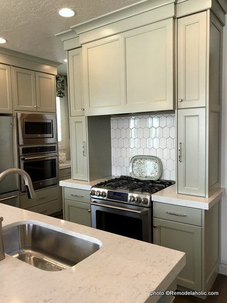 a kitchen with an oven, stove and sink in it's center island area