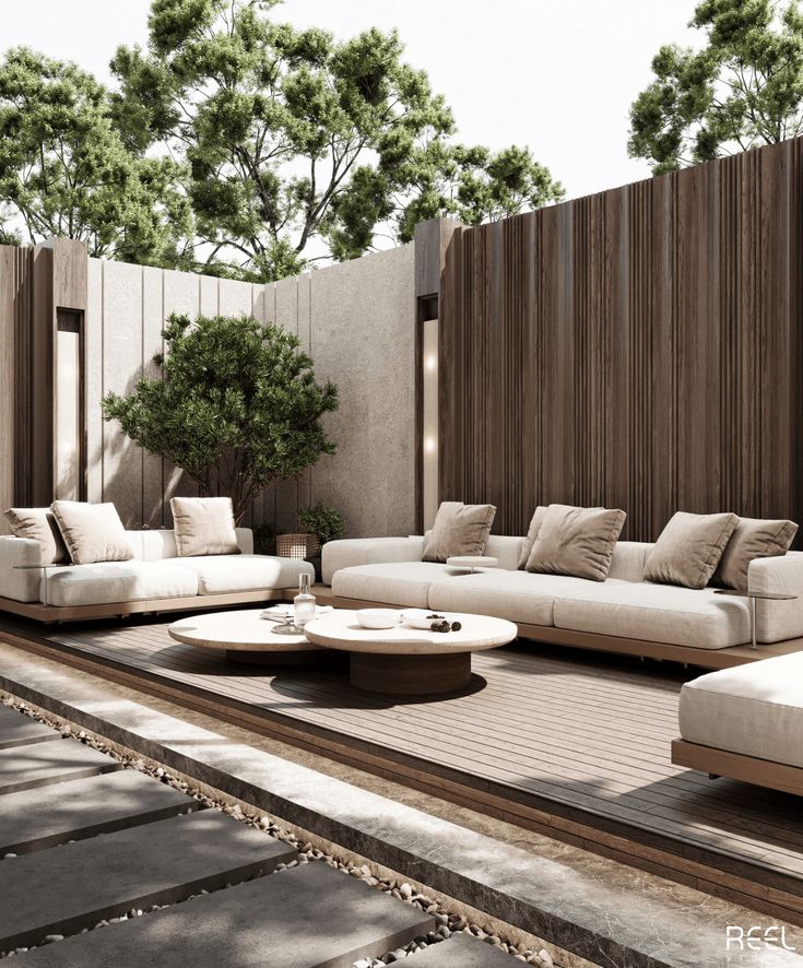 a living room with couches and tables in front of a fenced off area