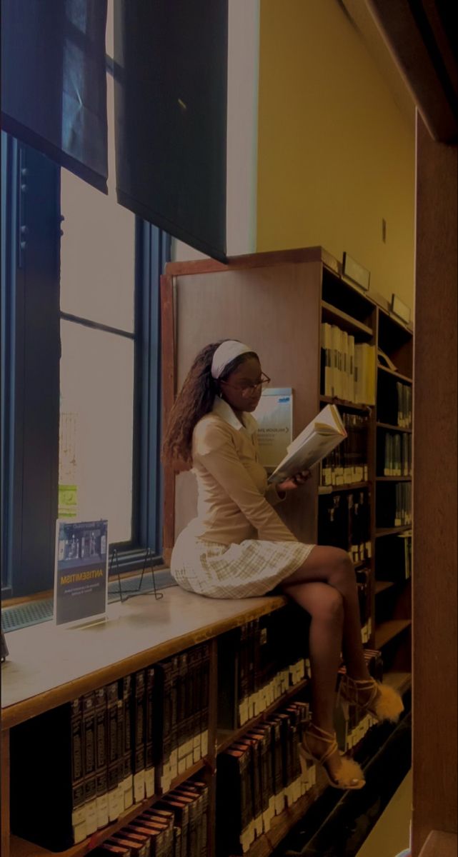 darkskin black woman reading in a library wearing a skirt, heels , and button up shirt Book Aesthetic Black Woman, Black Poet Aesthetic, Black Librarian Aesthetic, School Aesthetic Black Women, Black Church Girl Aesthetic, Black College Girl Aesthetic Studying, Black Author Aesthetic, Study Aesthetic Black Women, Artsy Black Girls Aesthetic