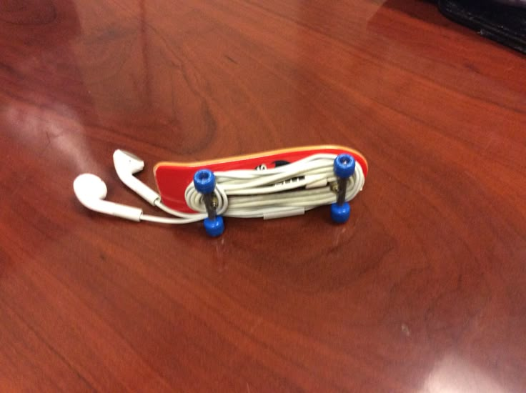 a red skateboard sitting on top of a wooden table