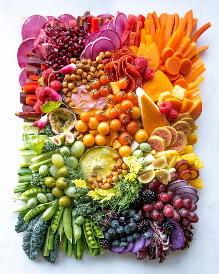 an arrangement of fruits and vegetables arranged in the shape of a square