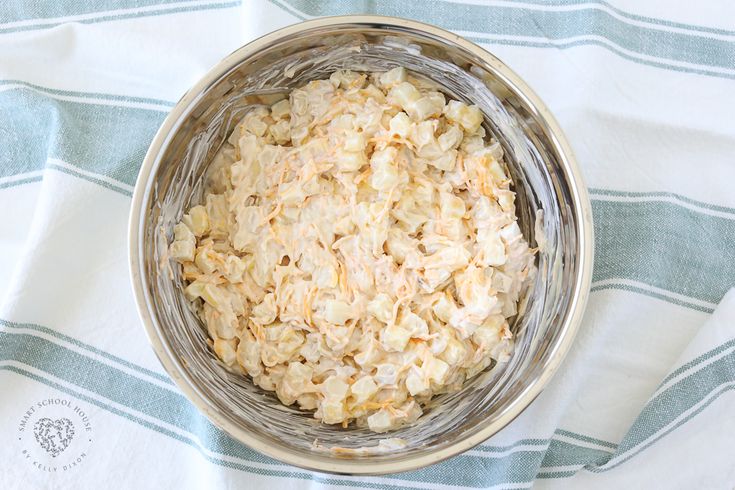 a bowl filled with rice sitting on top of a blue and white towel