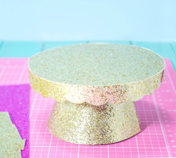 two pieces of cake sitting on top of a pink and purple cutting mat next to each other