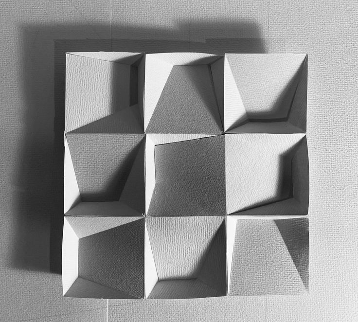 an abstract piece of art made out of white paper