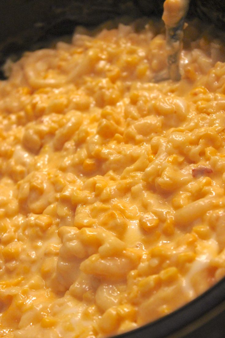 macaroni and cheese is being stirred in the pot