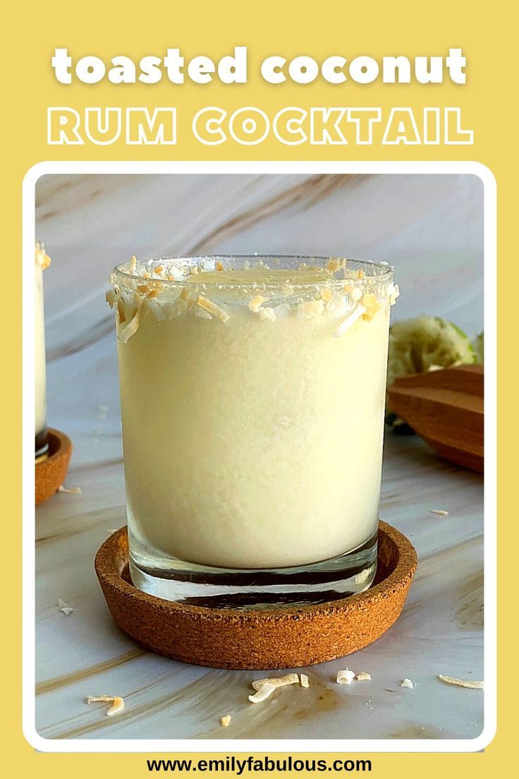 a close up of a drink in a glass on a table with the words toasted coconut rum cocktail