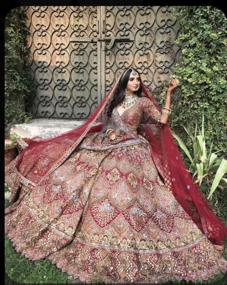 a woman in a red and gold wedding dress