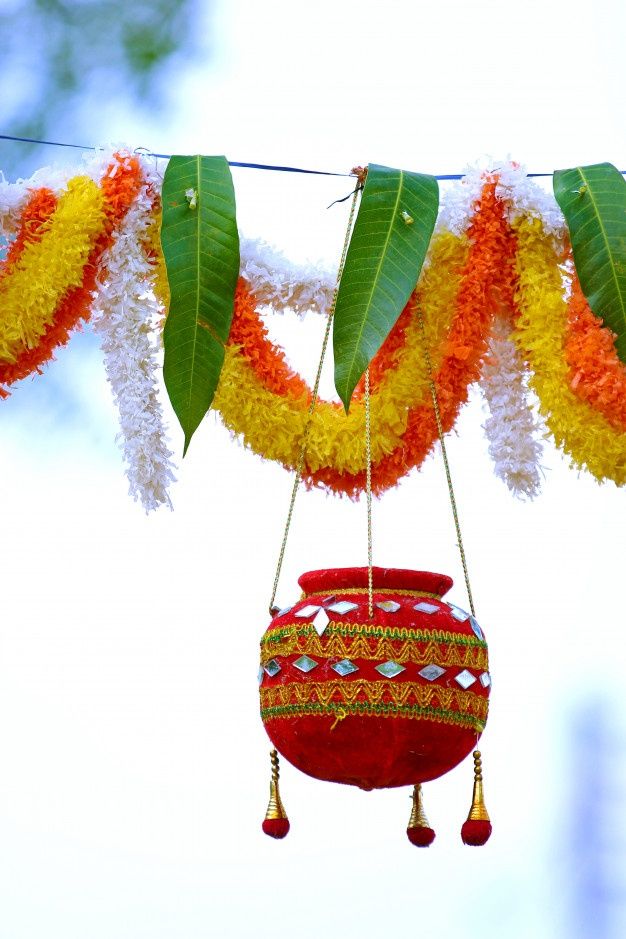 an orange and yellow flower pot hanging from a line