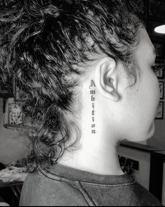 a woman with a tattoo on her neck