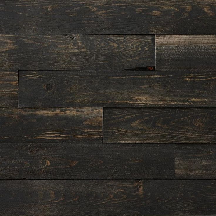 dark wood planks are stacked together on the wall