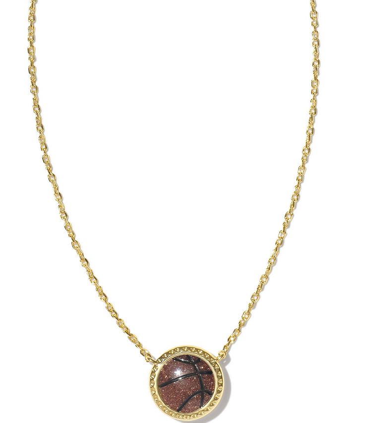 a gold necklace with a brown and black stone in the center, on a white background