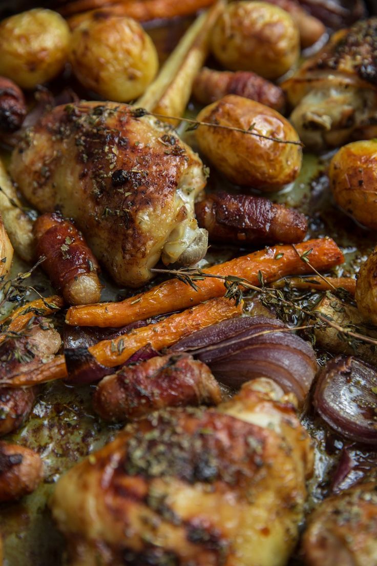 roasted vegetables and meat in a pan with herbs