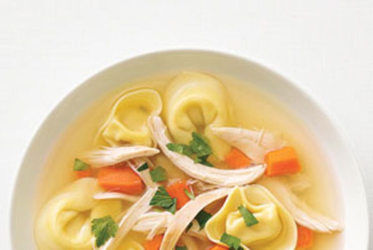 a white bowl filled with dumplings and carrots