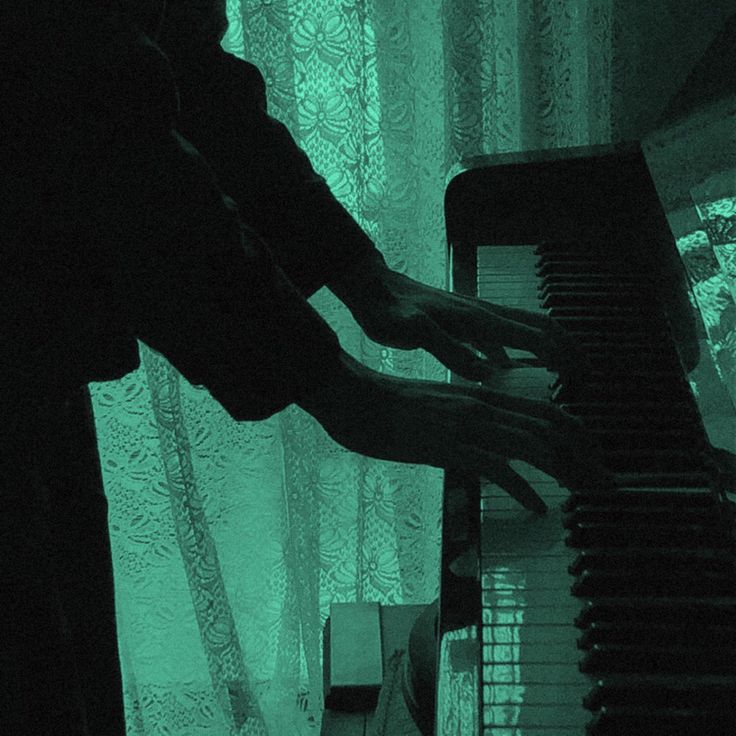 a person that is playing the piano in the dark