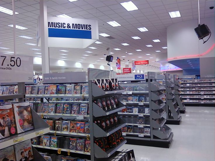 an empty store with music and movies on the shelves in it's center aisle