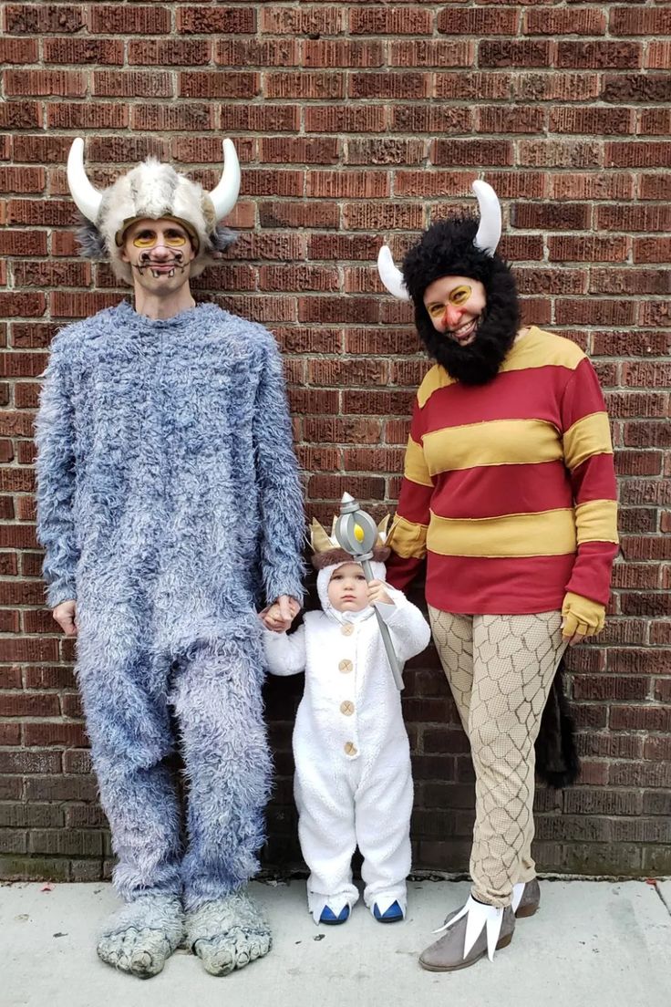 two men and a baby dressed up in costumes