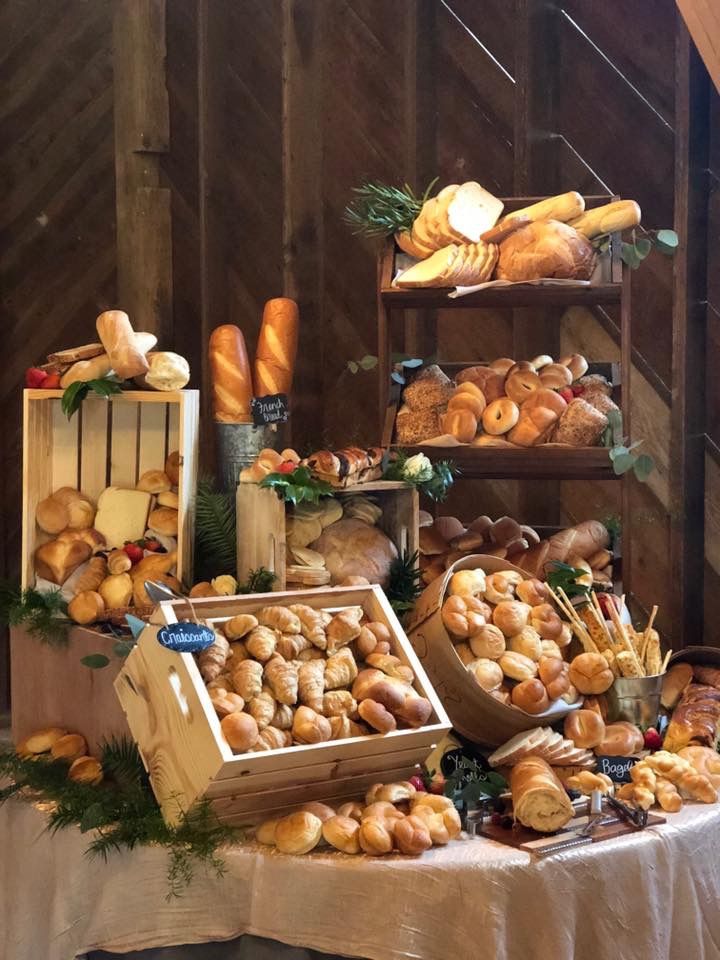 an assortment of breads and pastries displayed on a table