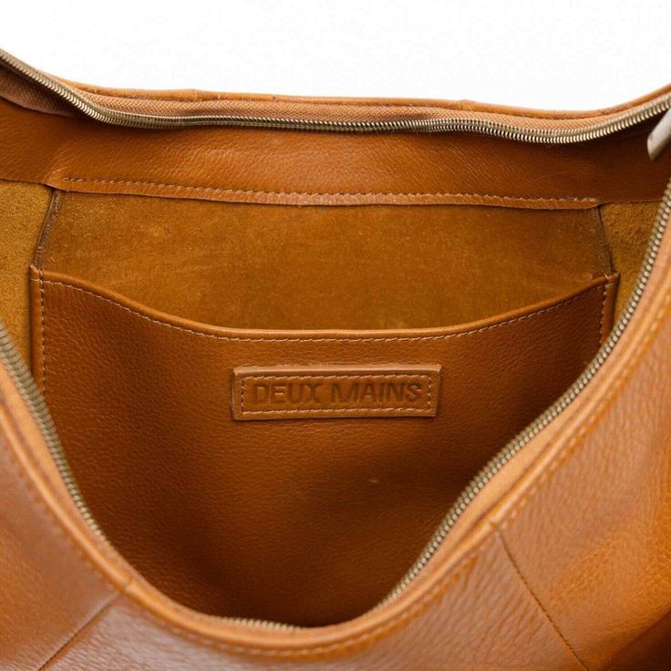 Make a bold statement with this handmade Saddle Shoulder bag in honey, crafted from the highest quality soft and supple genuine leather. Its classic hue adds a touch of elegance to any fall outfit, while the striking woven strap provides a modern edge. Handcrafted in Haiti, this limited production item is a testament to our commitment to sustainable fashion. Each piece is unique, showcasing exceptional craftsmanship and meticulous attention to detail. With ample room for your essentials, it effo Artisan Gift, Baguette Bag, Leather Conditioner, Mens Jewelry Bracelet, Fine Earrings, Women Accessories Bags, Independent Designers Fashion, Heart Jewelry, Handmade Artisan