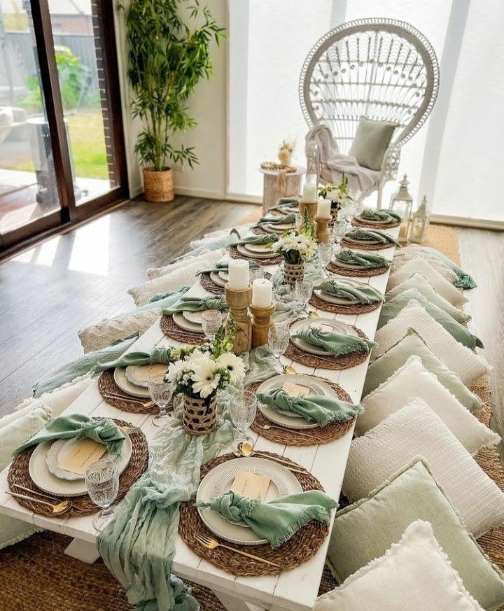 the table is set with place settings, plates and napkins for dinner guests to enjoy