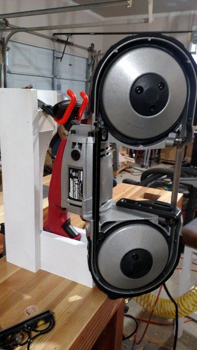 a pair of speakers sitting on top of a wooden table next to scissors and pliers