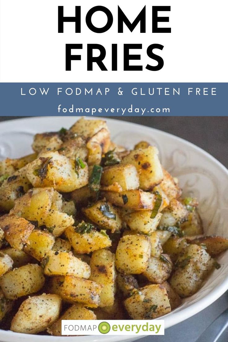 a white bowl filled with fried potatoes on top of a table