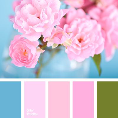 a vase filled with pink flowers on top of a blue table next to a wall