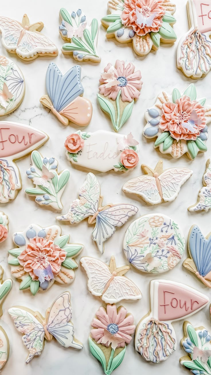 many decorated cookies with flowers and butterflies on them