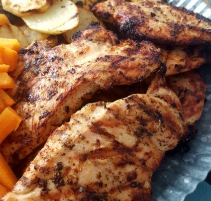 grilled chicken, carrots and potatoes on a paper plate