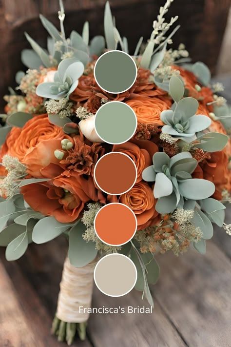 a bridal bouquet with orange flowers and greenery on the bottom, in shades of green