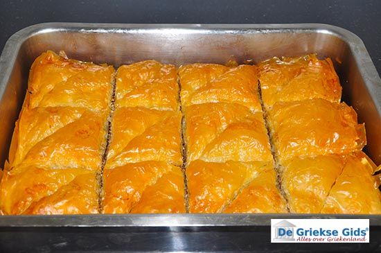 a pan filled with lots of food sitting on top of a stove