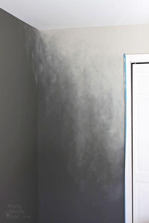 an empty room with gray paint on the walls